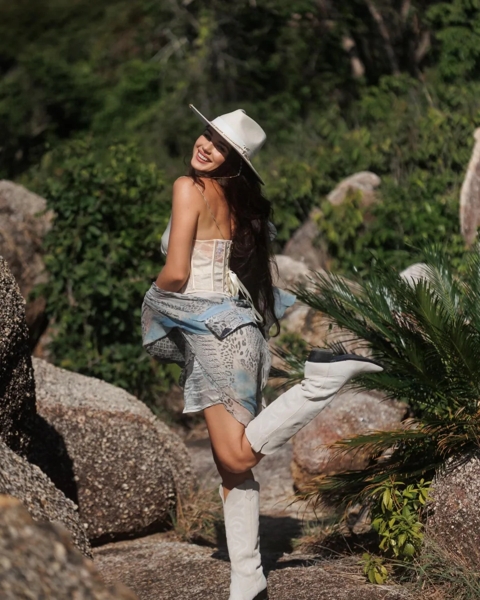 Svetlana smiling in a sunlit garden